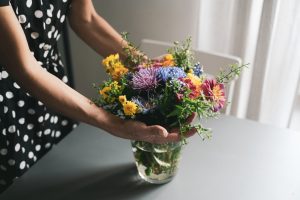 Colorful flowers in a vase on a table.